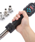Hand holding multi purpose heat gun for crafts and DIY projects with adjustable 212F to 932F air temperature and three nozzles.