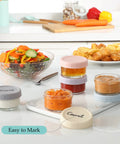 Six Pack 2.7 Oz Glass Salad Dressing Containers With Lids Leakproof Dipping Sauce Cups filled with condiments on kitchen counter