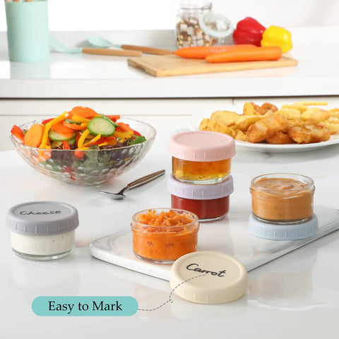 Six Pack 2.7 Oz Glass Salad Dressing Containers With Lids Leakproof Dipping Sauce Cups filled with condiments on kitchen counter