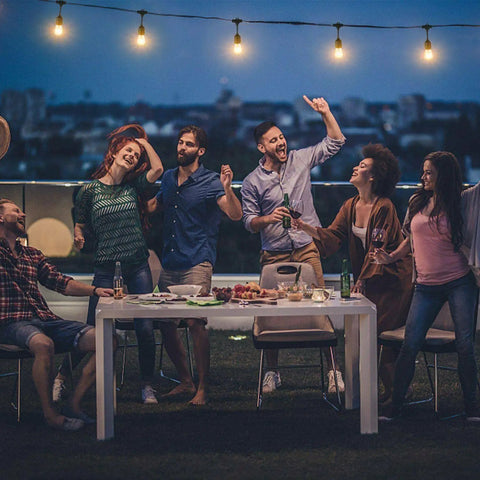 Outdoor LED String Lights 48Ft Heavy Duty Linkable Patio Lighting With Shatterproof Bulbs illuminate a joyful backyard gathering.