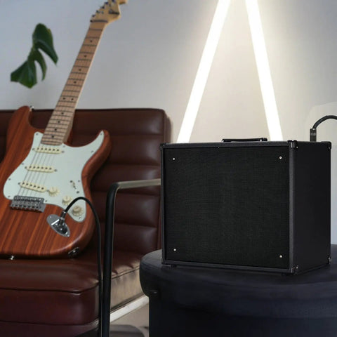 50W Electric Guitar Amp Combo With 10 Inch Speaker for home practice with guitar on a chair in a modern room setting.