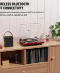 Cool Red Belt Drive Turntable For Vinyl Records With Bluetooth Output Connection Compatible With Active Speakers and Wireless Headphones stylishly placed on a wooden shelf.