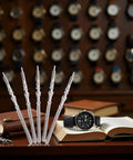 Five Piece Silver Steel Watch Stem Crown Kit For NH35 NH36 NH38 NH39 Movements with watch and books in background