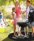 Family barbecuing on Round Fire Pit Mat For Bonfire And Outdoor Cooking Built To Take The Heat Heavy Duty Fireproof Under Grill Mat