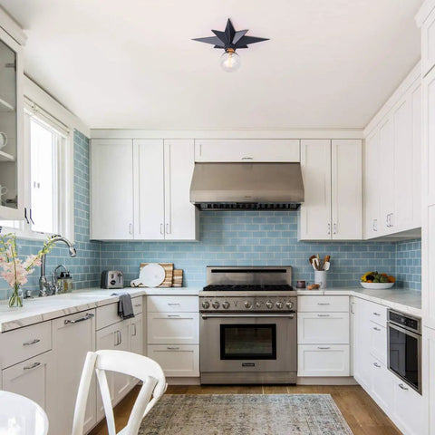Modern kitchen with Black Star Flush Mount Ceiling Light With Dope Mid Century Vibe, white cabinets, and stainless steel appliances.