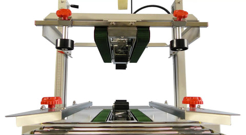 Versatile Case Sealer And Adjustable Top And Bottom Tape Dispenser Zero Stress Smooth Operator For Custom Shipping Boxes viewed from above, showcasing dual belts and controls.