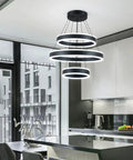 Modern Black LED Ring Chandelier With Three Adjustable Tiered Cylinders Hangs Flawlessly Over Kitchen Islands Or Bedrooms Quick Install Setup in a sleek kitchen.