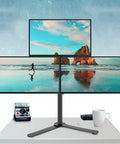 Rock Solid Triple Monitor Stand Built Like A Tank Heavy Duty Full Motion Adjustable Arms With Sturdy Metal Base Fits Up To Twenty Seven Inch Screens on a desk with scenic backgrounds.