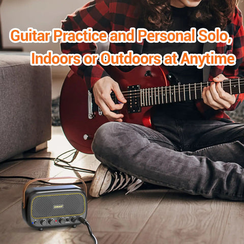 Person playing guitar with Portable 5W Mini Guitar Amplifier For Electric Guitars With Dual Speakers Rechargeable Battery Bluetooth And Clean Overdrive Effects Perfect For Practice On The Go placed nearby on the floor.