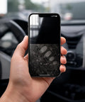Smartphone with fingerprint marks in car, demonstrating 2 Pack Car And Device Screen Cleaner Spray And Wipe 2 In 1 Touchscreen Mist Cleaner.