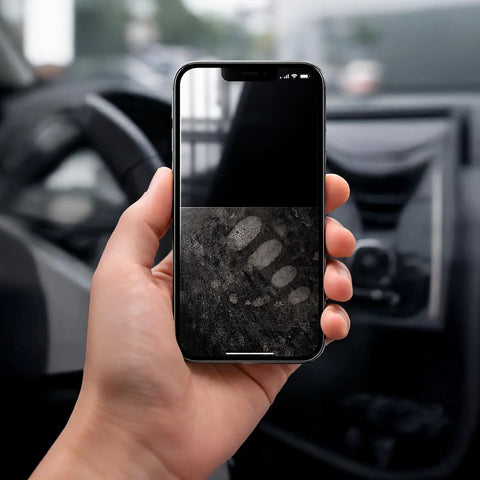Smartphone with fingerprint marks in car, demonstrating 2 Pack Car And Device Screen Cleaner Spray And Wipe 2 In 1 Touchscreen Mist Cleaner.