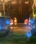 Pathway lit by Blue Solar Torch Lights Set, 8 Pack Outdoor LED Tiki Torches With Realistic Flickering Flame, 12 LEDs, Waterproof Landscape Decor