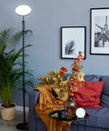 Lit 24W LED Daylight Floor Lamp Free Standing Uplight Torchiere in living room near sofa and decor with black finish