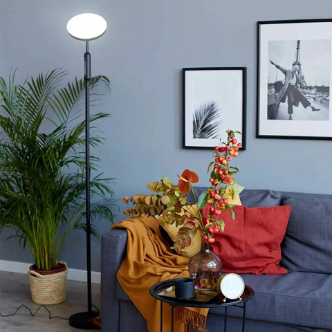 Lit 24W LED Daylight Floor Lamp Free Standing Uplight Torchiere in living room near sofa and decor with black finish