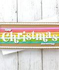Crafted card with Strip Frame Metal Die Cut Set for Scrapbooking, featuring colorful stripes and 'Merry Christmas' text on wooden background.