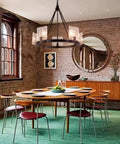 5 Light Black Farmhouse Chandelier for Dining Room and Foyer in rustic dining room setting with circular table.