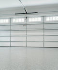 Wide view of closed steel sectional garage door with Garage Door Torsion Spring Upgrade 0.207 Inch Wire Size installed, interior view.