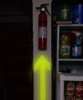 Bright yellow arrow pointing to a fire extinguisher beside kitchen pantry items.