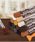 Wood Filler Sticks Kit With 16 Colors For Scratches, Scuffs, Cracks And Holes Easy Touch Up For Furniture, Floors, Cabinets And Doors Color Match White Oak, Mahogany, Walnut, Maple, Black And More displayed with color sticks and scraper.