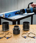 Polymer Dust Right Quick Change Multi Port Tool Set With Quick Change Handle For Dust Collection 2.5 To 4 Inch Tool Ports And 4 Inch Keyed Bridge Hose Clamps No Fuss Easy Flexible Dust Collection Setup displayed near a table saw with handles, ports, and clamps.