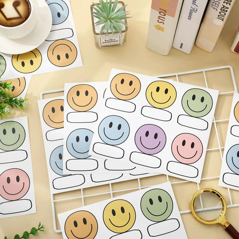 Smiley Name Tags Pack 120 Pcs Boho Pastel Smile Face Nameplates for Classroom and Office Labeling on a table