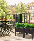 Raised Garden Beds Planter Box Set Of 2 With Self Watering Design Plastic Planter for outdoor use on a balcony with plants