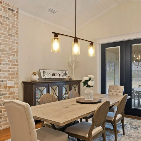 Dining room with three light modern chandeliers for kitchen island pendant lighting, wrought iron and glass shade.