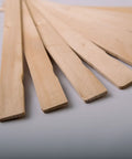 American-Made Basswood Paint Stir Sticks 21 Inch Bulk 250 Count laid out in a fan pattern for 5-Gallon Buckets