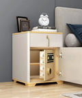 Modern white nightstand with open safe below, decorated with clock and books beside a gray sofa in a living room setting.