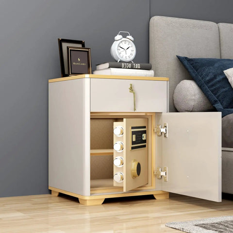 Modern white nightstand with open safe below, decorated with clock and books beside a gray sofa in a living room setting.
