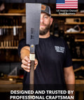 Pro Grade Japanese Pull Saw With Dual Rip And Crosscut Blades held by a craftsman in a workshop, showcasing its sharp blade design.