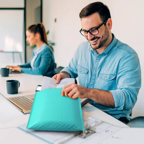 Man using teal bubble mailers 10.5x16 inch self seal padded envelopes waterproof 40 pack usable 10.5x15 size for shipping