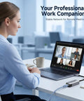 Woman using USB-C to 10Gb Ethernet adapter with USB4 and Thunderbolt 5/4/3 compatibility for stable conference call connection.