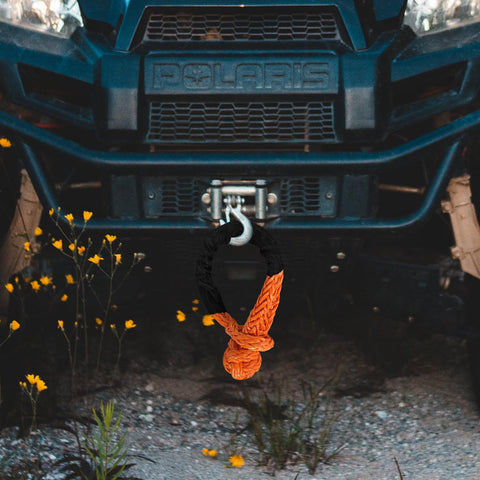 Beefy Half Inch By Twenty Two Feet Recovery Shackle For Off Road SUVs ATVs And Trucks Synthetic Orange With Sleeves attached to vehicle bumper