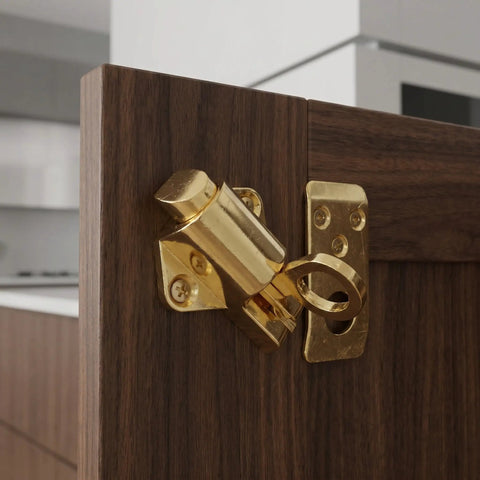 Spring Loaded Zinc Alloy Cabinet Lock with Self Locking Bolt installed on a wooden cabinet door in a kitchen setting.