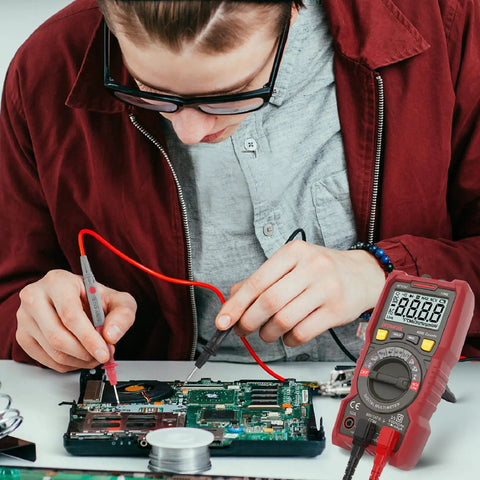 Person using DIY Ready Pro Grade TRMS 6000 Counts Digital Multimeter With Auto Ranging NCV Capability on electronic circuit board
