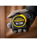 Fatmax Tape Measure With Blade Armor And Dual Scale 8m Length, Mylar Coated Blade Delivers 10x Abrasion Resistance held in hand