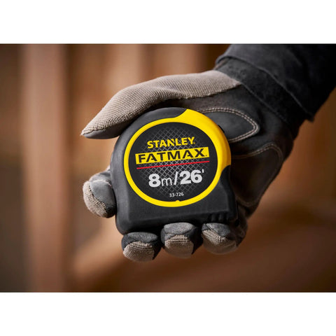 Fatmax Tape Measure With Blade Armor And Dual Scale 8m Length, Mylar Coated Blade Delivers 10x Abrasion Resistance held in hand
