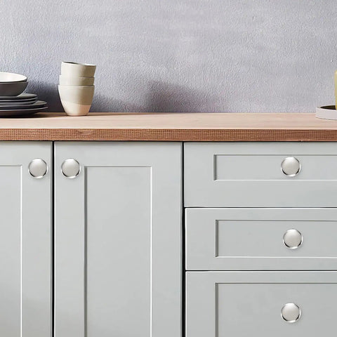 Top Shelf 10 Pack 1-1/4 Inch Heavy Duty Solid Round Cabinet Knobs Polished Nickel on grey kitchen cabinetry.