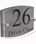 House number sign on acrylic panel with metal standoffs displaying '26 Driver Close'