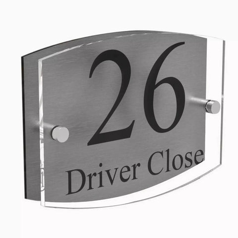 House number sign on acrylic panel with metal standoffs displaying '26 Driver Close'