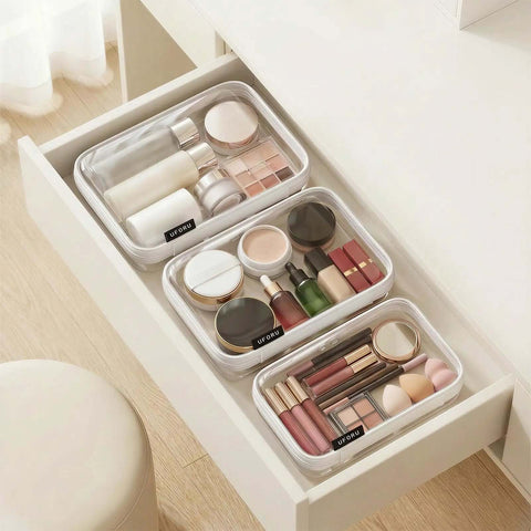 Ridiculously Tough Clear Hard Shell Zipper Cases Including Three Diaper Bag Organizer Pouches filled with makeup and toiletries in a drawer.