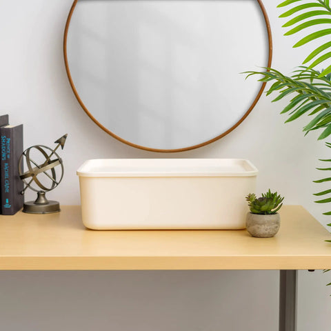 Off-white 15 Quart Plastic Storage Bin With Lid on a desk, part of a 4 pack stackable organizer for kitchen, bathroom, and bedroom.