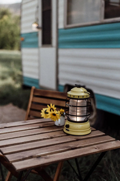 Dusty Yellow Forest Lantern Vintage Rechargeable LED Lantern With Adjustable Brightness on wooden camping table