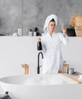 Five Pack 15A GFCI Outlet With LED Indicator, Self Test, visible behind person in white bathrobe, luxury bathroom setting