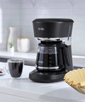 Natural Unbleached Brown Biodegradable Extra Large Coffee Filters For 10 To 15 Cup Baskets next to coffee maker on counter