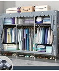 Hella Spacious Portable Wardrobe Closet With Reinforced Metal Frame And Dual Hanging Rods Quick Assembly Clothes Organizer With Airy Fabric Cover For Cozy Bedroom Gear Storage Green filled with neatly organized clothes and accessories.