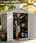 Man standing inside 6x4.4 Ft Resin Outdoor Storage Shed With Floor Lockable Doors And Windows All Weather Plastic Garden Tool Shed