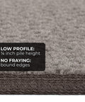 Close-up of gray non-slip carpet stair tread, showing low profile 1/4 inch pile height and bound edges for durability.