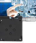 RF A60 Linear Stage Translation Platform with manual angle square micrometer, shown in lab setup, against machinery backdrop.
